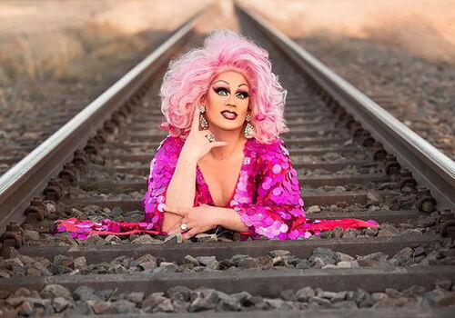 Person in pink auf Bahnschienen liegend