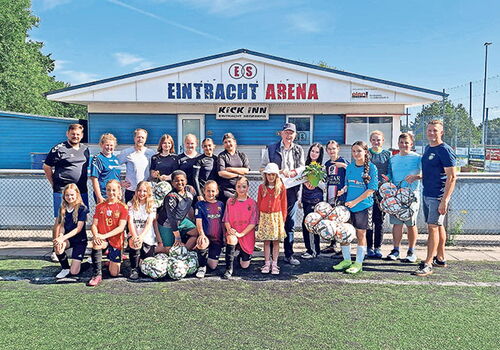 Gruppe von Fußballspielern und Trainern vor Eintracht Arena