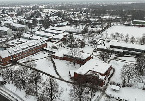 Luftbild einer schneebedeckten Stadtlandschaft im Winter.