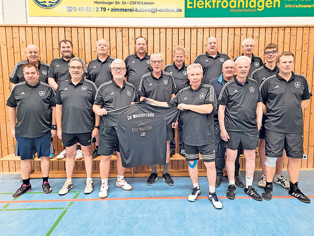 Sportteam mit T-Shirt in der Turnhalle Sportteam in schwarzer Sportkleidung in einer Turnhalle.
