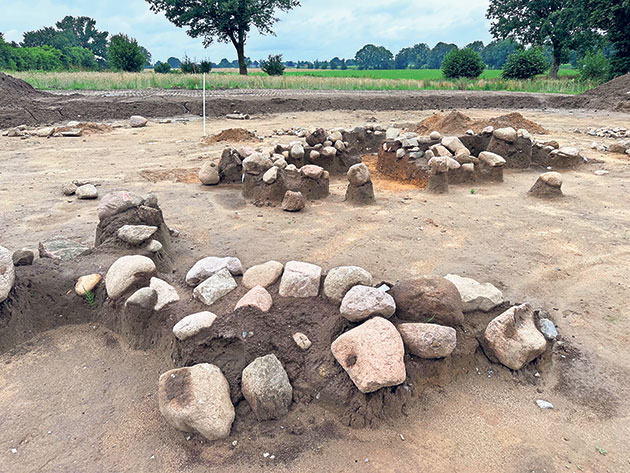Ausgrabung einer bronzezeitlichen Grabanlage auf freiem Feld.