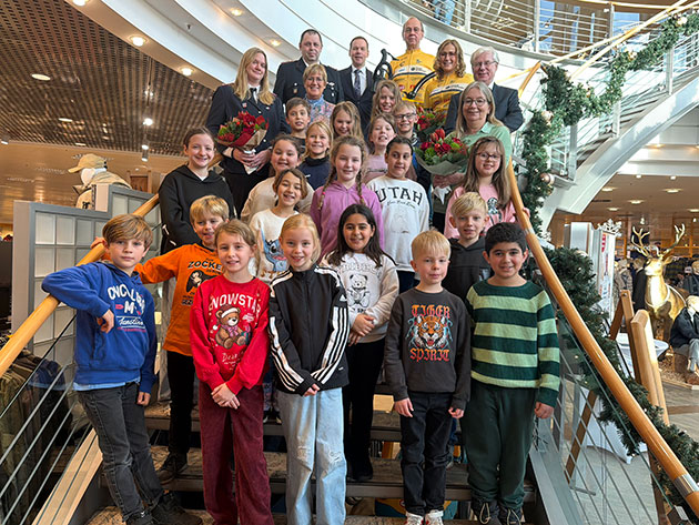 Kinder und Erwachsene auf einer Treppe in Weihnachtsdekor.
