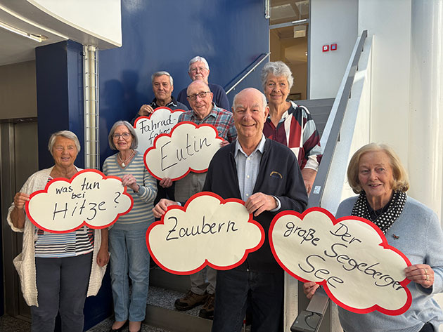 Ältere Personen halten Sprechblasen mit Text.